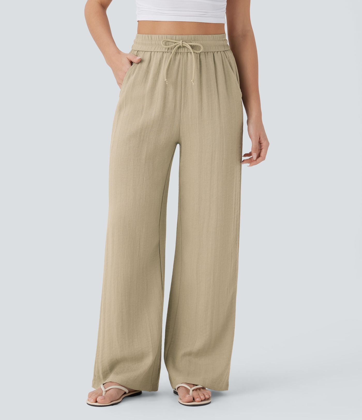 Pantalon large fluide taille haute avec cordon de serrage, poches latérales et aspect lin