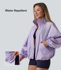 Veste de sport déperlante col montant manches longues zippée avec poches