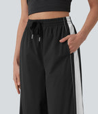 Pantalon running large à rayures taille haute avec cordon de serrage, séchage rapide et effet frais InstantCool avec poches, protection solaire UPF40+