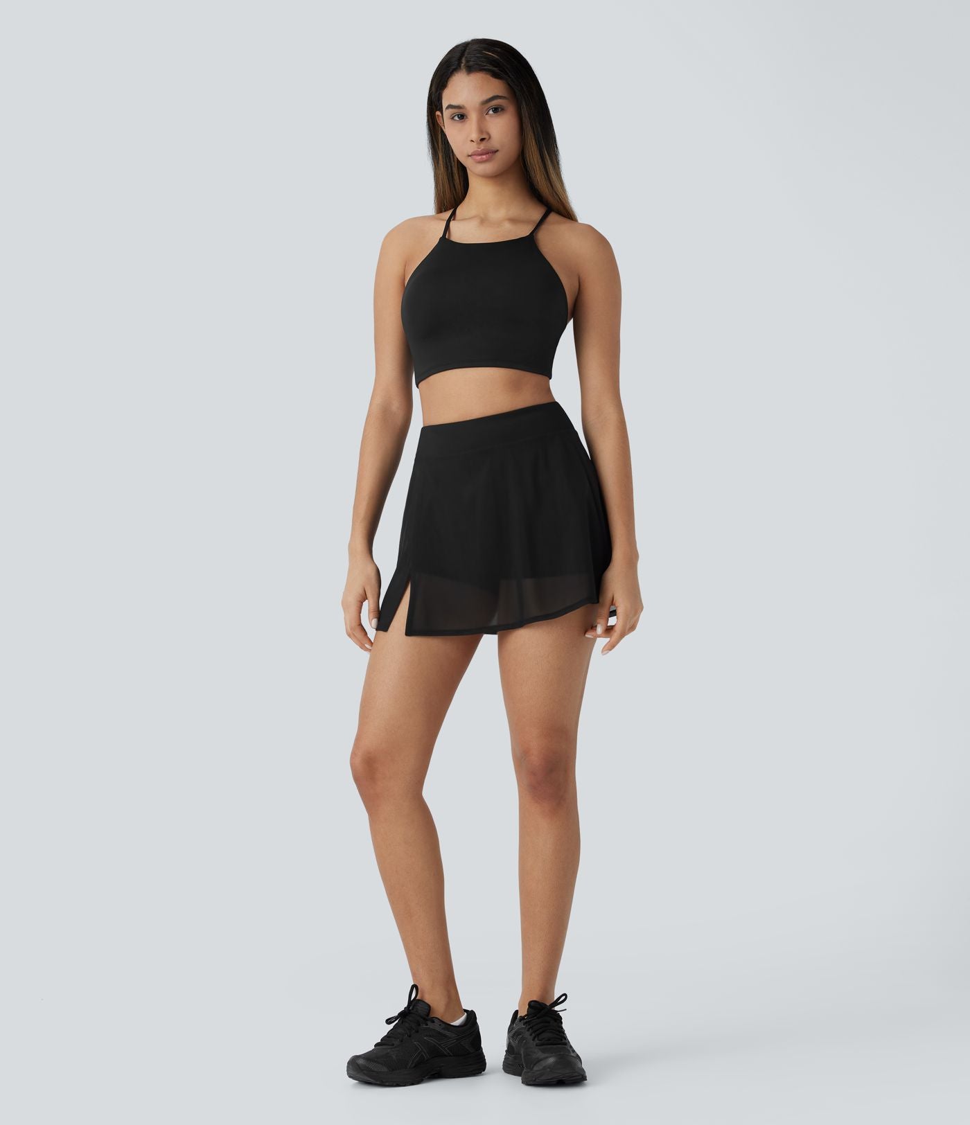 Mini-jupe de yoga taille haute avec short intégré, poches latérales et empiècements en maille contrastée avec fentes