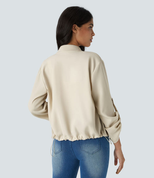 Blouson décontracté à col montant, manches retroussables, poches à rabat, cordon de serrage intérieur et fermeture éclair
