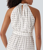 Robe mi-longue fluide de vacances à pois avec col licou, découpe dos, ceinture et poches latérales