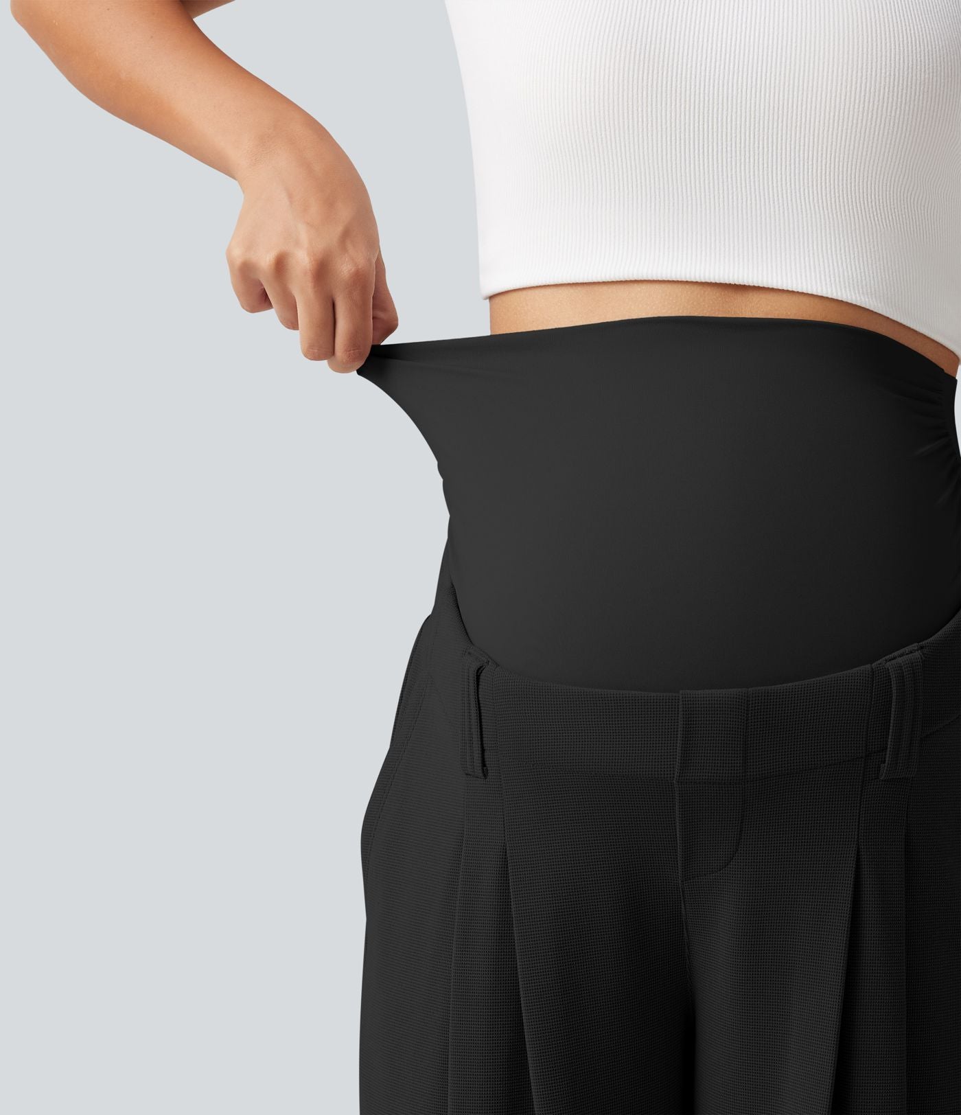 Pantalon de grossesse fuselé taille très haute en tissu gaufré avec poches