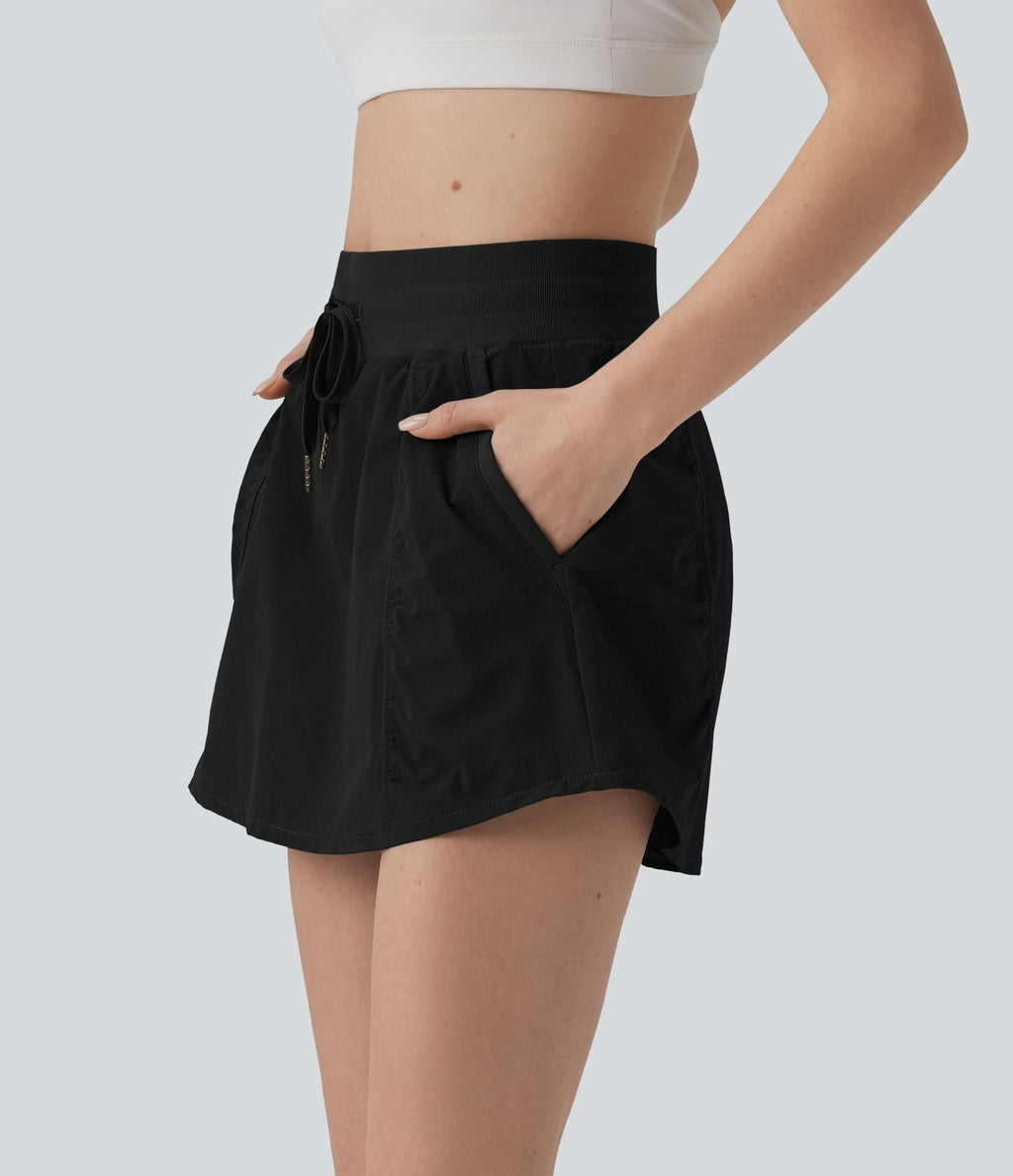 Jupe de sport mini 2-en-1 taille haute coupe trapèze avec cordon de serrage et poches