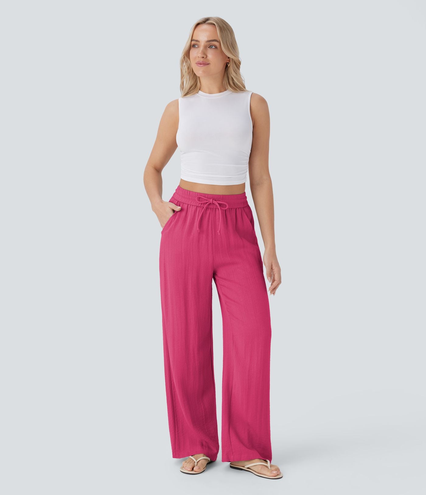 Pantalon large fluide taille haute avec cordon de serrage, poches latérales et aspect lin