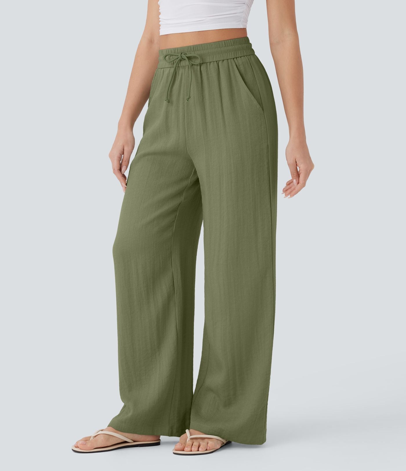 Pantalon large fluide taille haute avec cordon de serrage, poches latérales et aspect lin