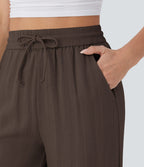 Pantalon large fluide taille haute avec cordon de serrage, poches latérales et aspect lin