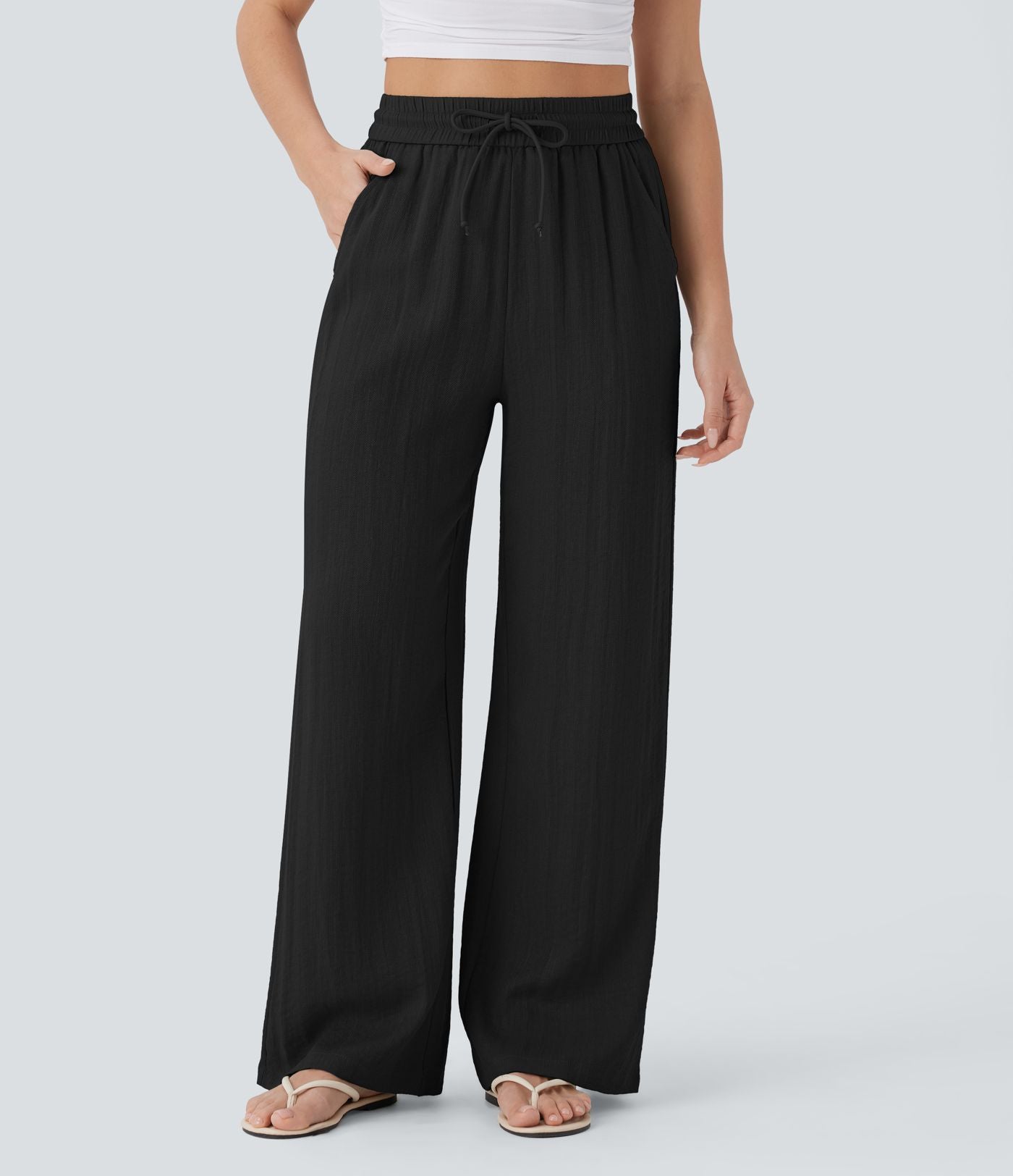 Pantalon large fluide taille haute avec cordon de serrage, poches latérales et aspect lin