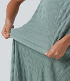 Robe midi sans manches à encolure arrondie avec coussinets amovibles et ourlet à volants