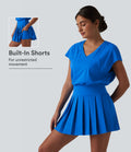 Robe sport de tennis mini 2-en-1 à col V, manches courtes et ourlet plissé avec fermeture éclair invisible et poches