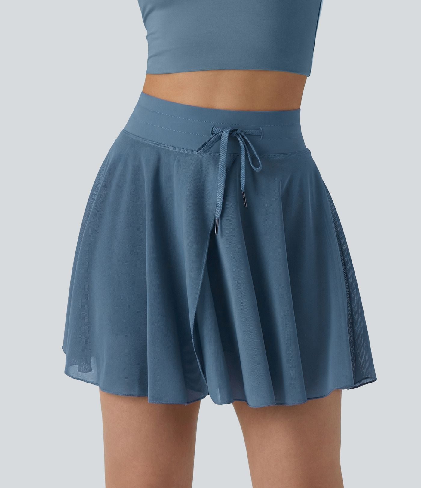 Jupe mini fluide évasée 2-en-1 taille haute à cordon, empiècements en mesh contrastant, avec poche, version plus longue