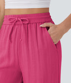 Pantalon large fluide taille haute avec cordon de serrage, poches latérales et aspect lin