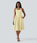Robe midi fluide sans manches décolleté cœur avec bretelles croisées, nœud dans le dos et poches