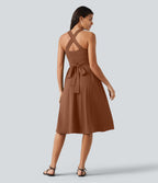 Robe midi fluide sans manches décolleté cœur avec bretelles croisées, nœud dans le dos et poches