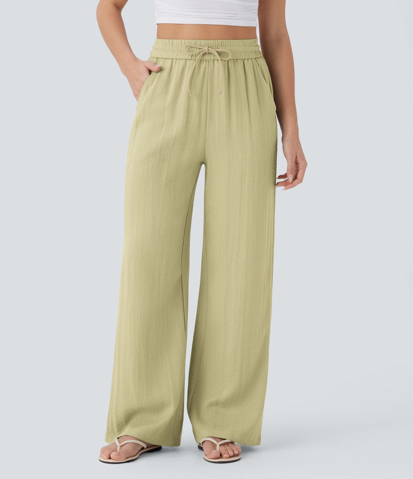 Pantalon large fluide taille haute avec cordon de serrage, poches latérales et aspect lin