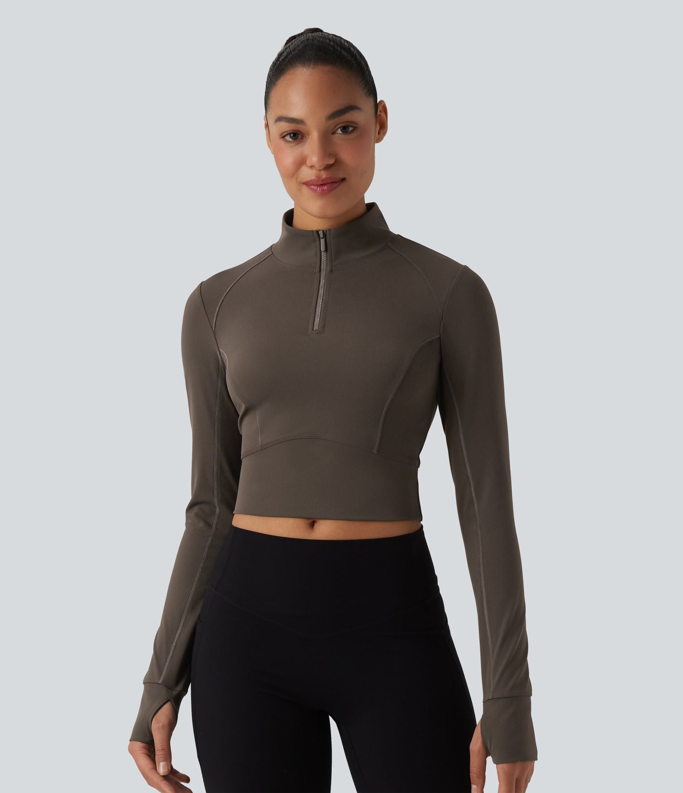 Haut de sport court col cheminée demi-zip manches longues avec passe-pouces