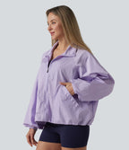 Veste de sport déperlante col montant manches longues zippée avec poches