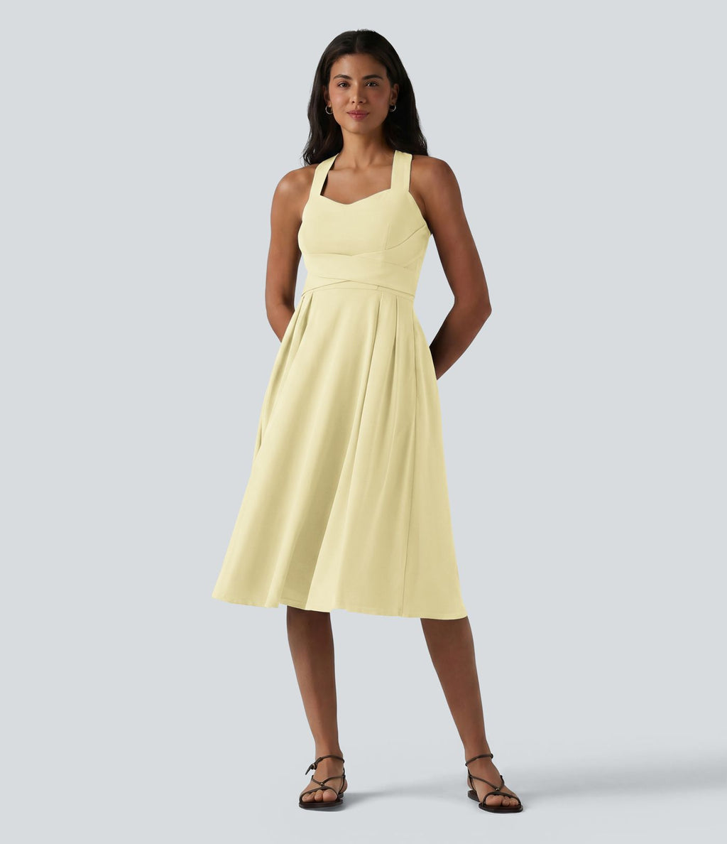 Robe midi fluide sans manches décolleté cœur avec bretelles croisées, nœud dans le dos et poches