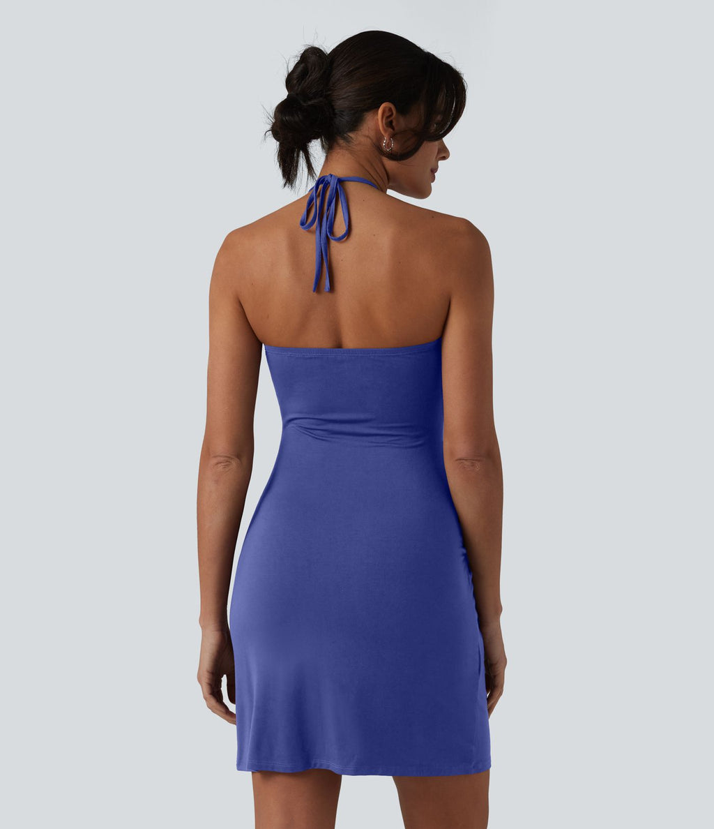 Robe resort mini dos nu à col licou avec lien noué dans le dos et poches