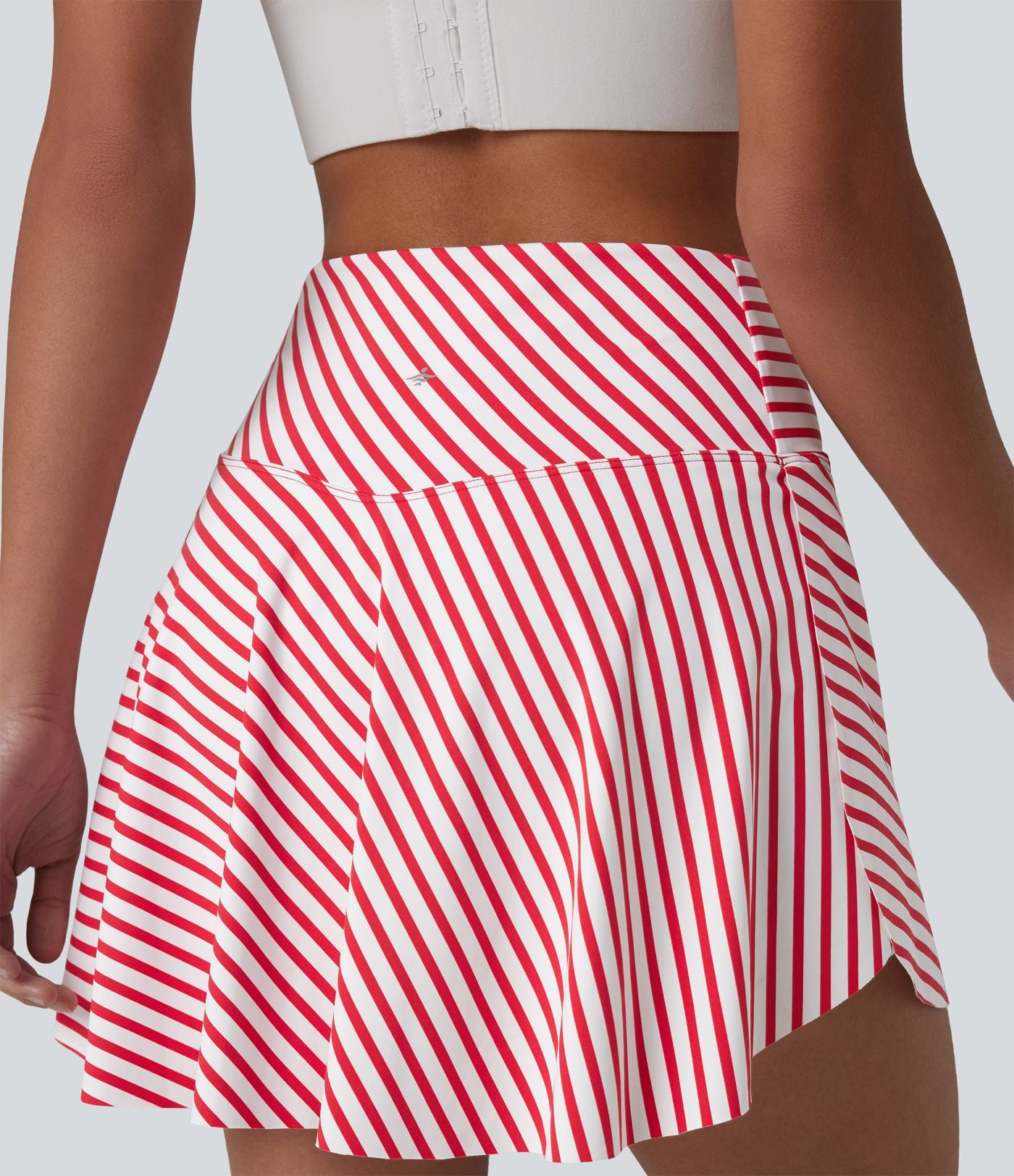 Jupe de tennis mini 2 en 1 à rayures, taille haute croisée, ourlet arrondi et poches