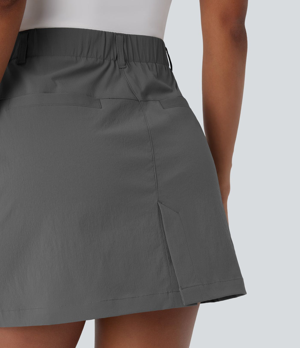 Jupe courte de golf ligne A taille haute avec boutons, zip, poches latérales et fente
