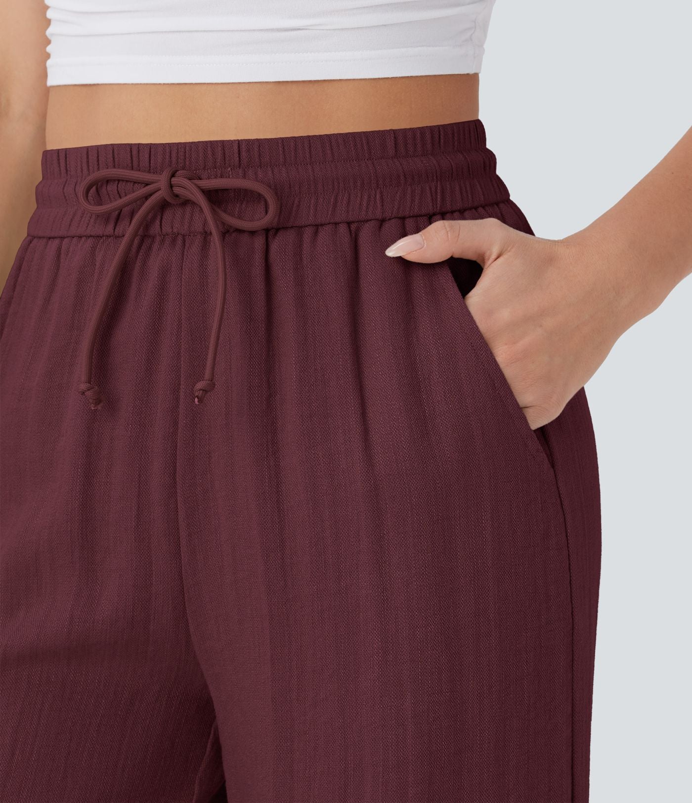 Pantalon large fluide taille haute avec cordon de serrage, poches latérales et aspect lin
