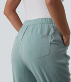 Pantalon tailleur aspect lin fuselé taille haute asymétrique avec poches