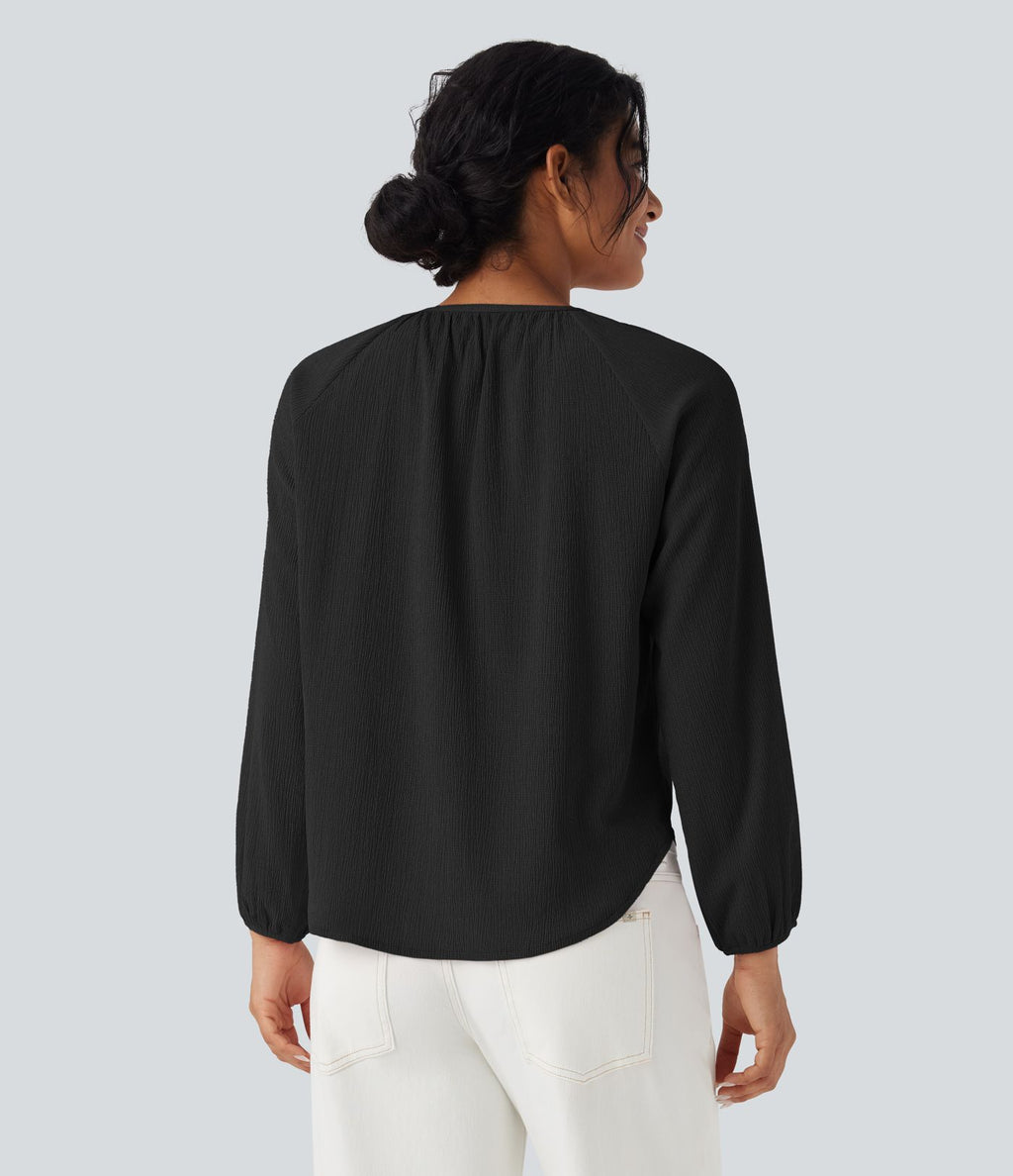 Blouse texturée col rond manches longues ourlet arrondi