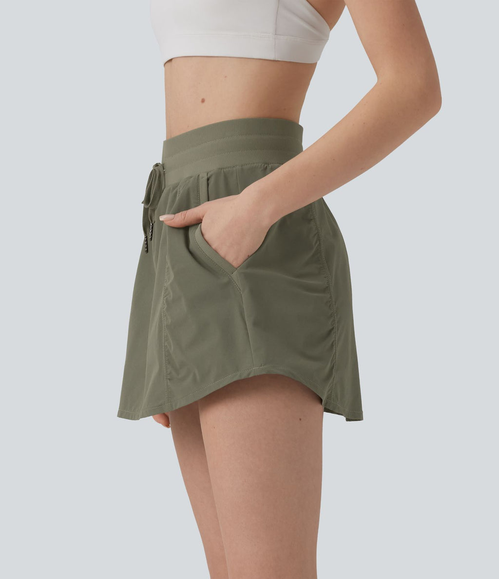 Jupe de sport mini 2-en-1 taille haute coupe trapèze avec cordon de serrage et poches