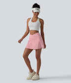 Jupe de tennis mini 2 en 1 à rayures, taille haute croisée, ourlet arrondi et poches