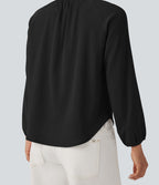 Blouse texturée col rond manches longues ourlet arrondi
