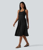 Robe midi fluide sans manches décolleté cœur avec bretelles croisées, nœud dans le dos et poches