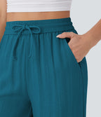 Pantalon large fluide taille haute avec cordon de serrage, poches latérales et aspect lin