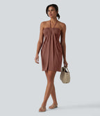 Robe resort mini dos nu à col licou avec lien noué dans le dos et poches