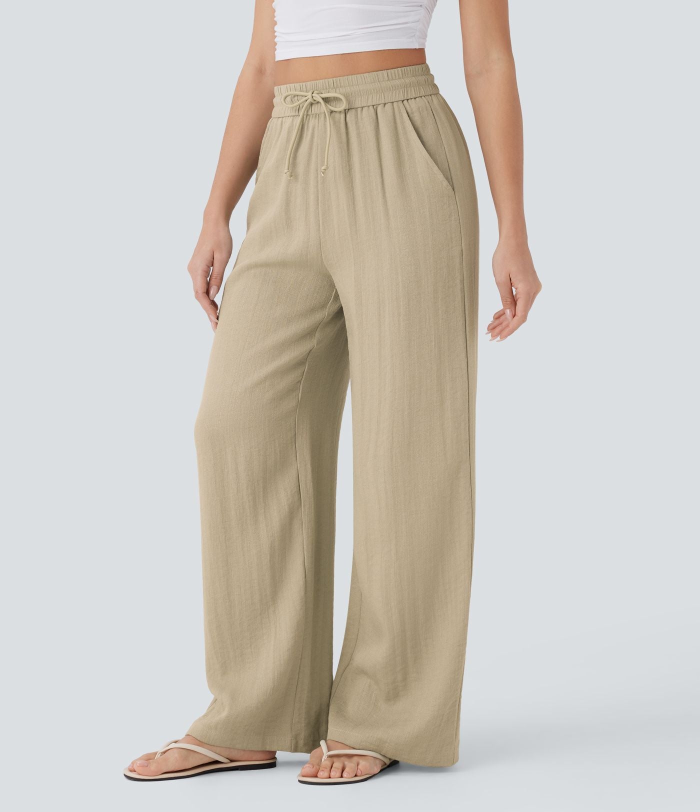 Pantalon large fluide taille haute avec cordon de serrage, poches latérales et aspect lin