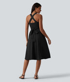 Robe midi fluide sans manches décolleté cœur avec bretelles croisées, nœud dans le dos et poches