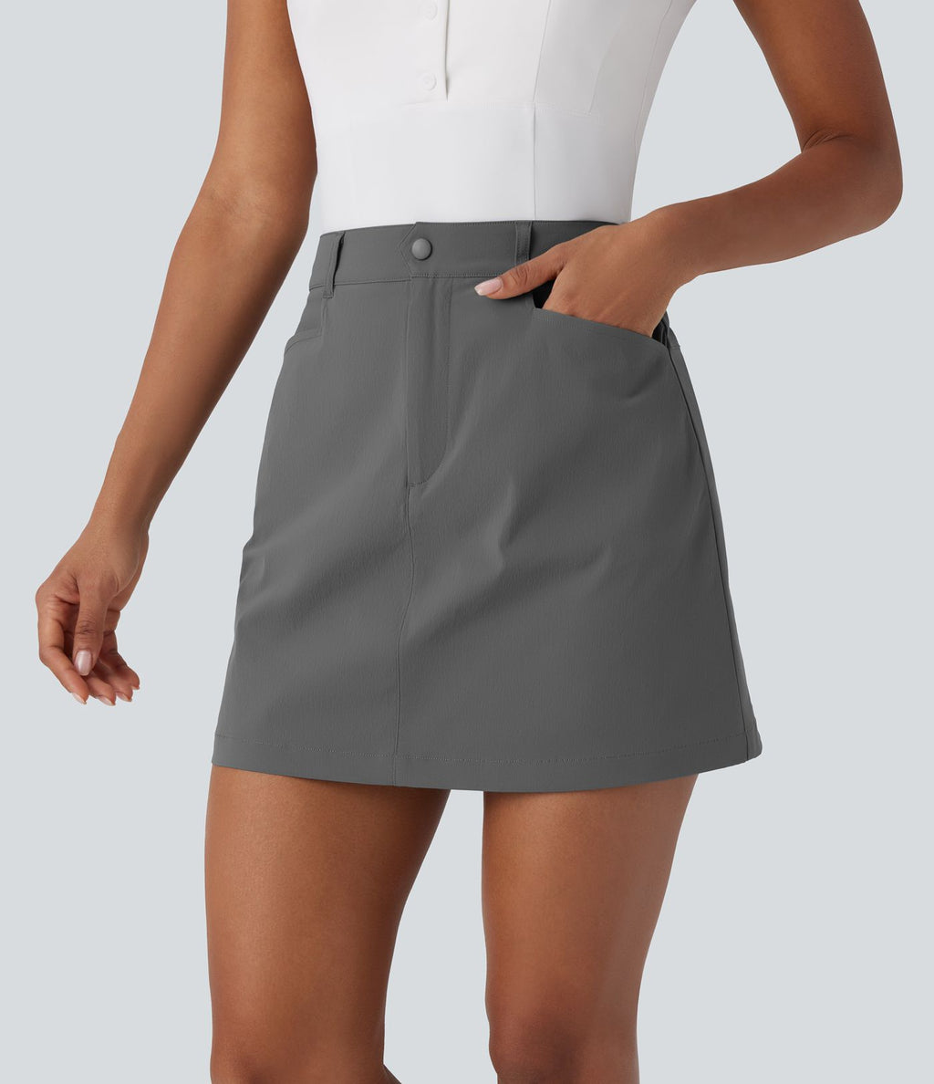 Jupe courte de golf ligne A taille haute avec boutons, zip, poches latérales et fente