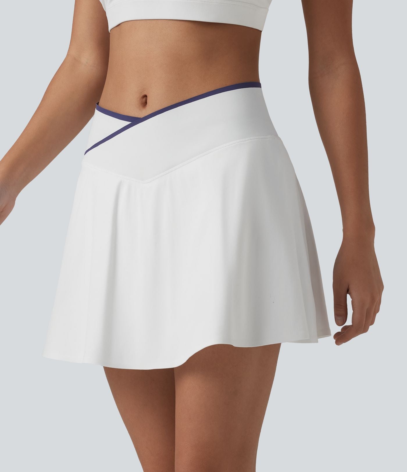 Jupe de tennis mini 2-en-1 color block croisée taille mi-haute avec poches
