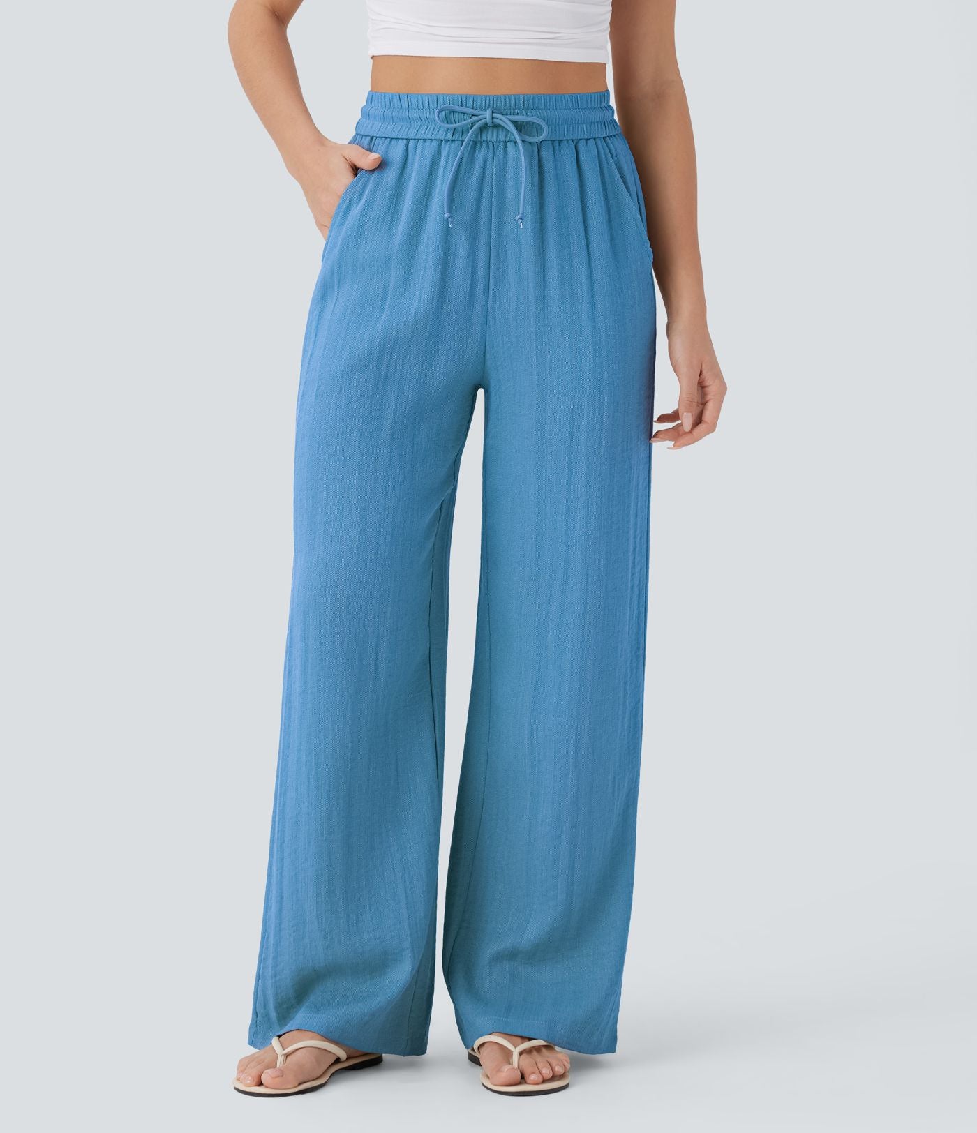 Pantalon large fluide taille haute avec cordon de serrage, poches latérales et aspect lin