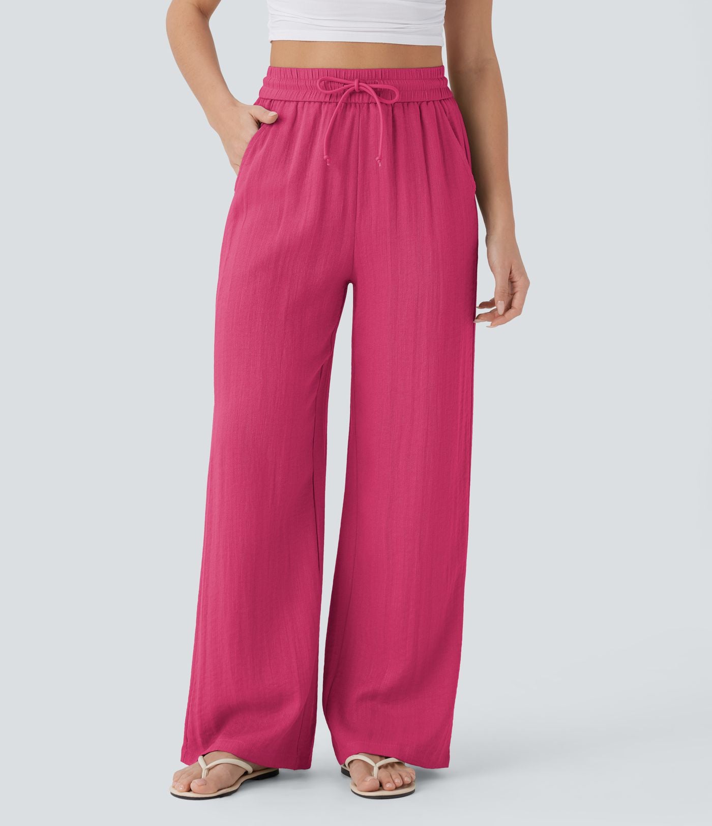 Pantalon large fluide taille haute avec cordon de serrage, poches latérales et aspect lin