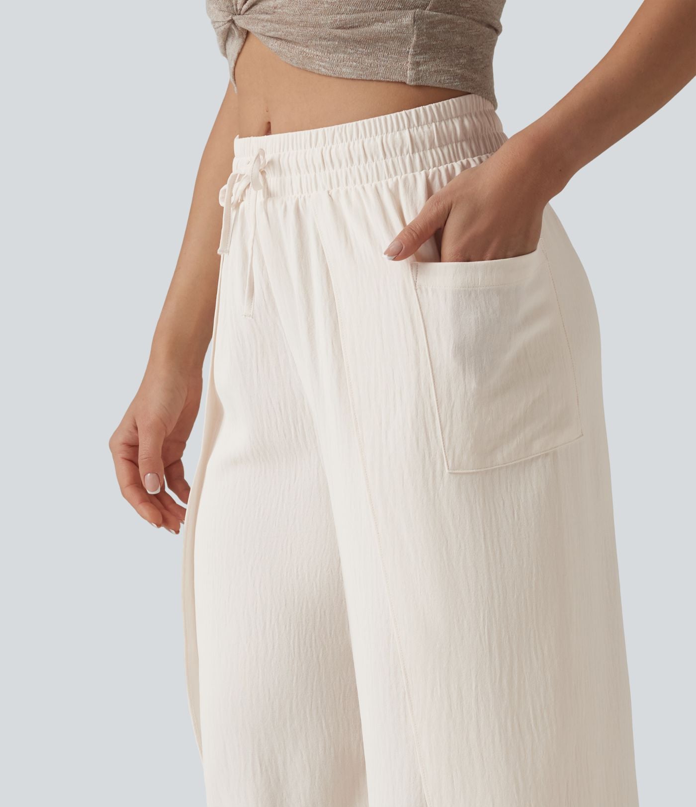 Pantalon ample décontracté à taille mi-haute, fentes, aspect lin, cordon de serrage et poches