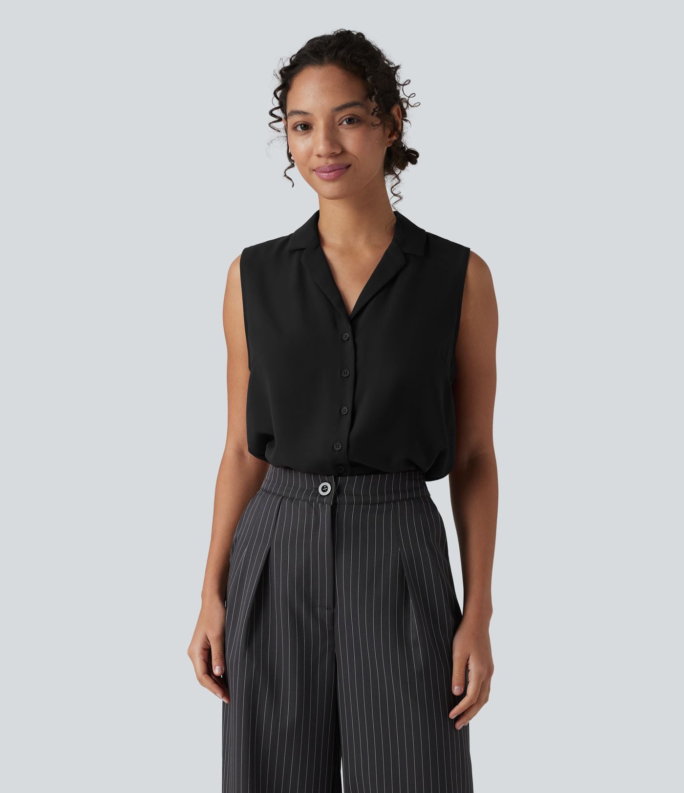 Blouse tailleur ample col revers sans manches à boutonnière