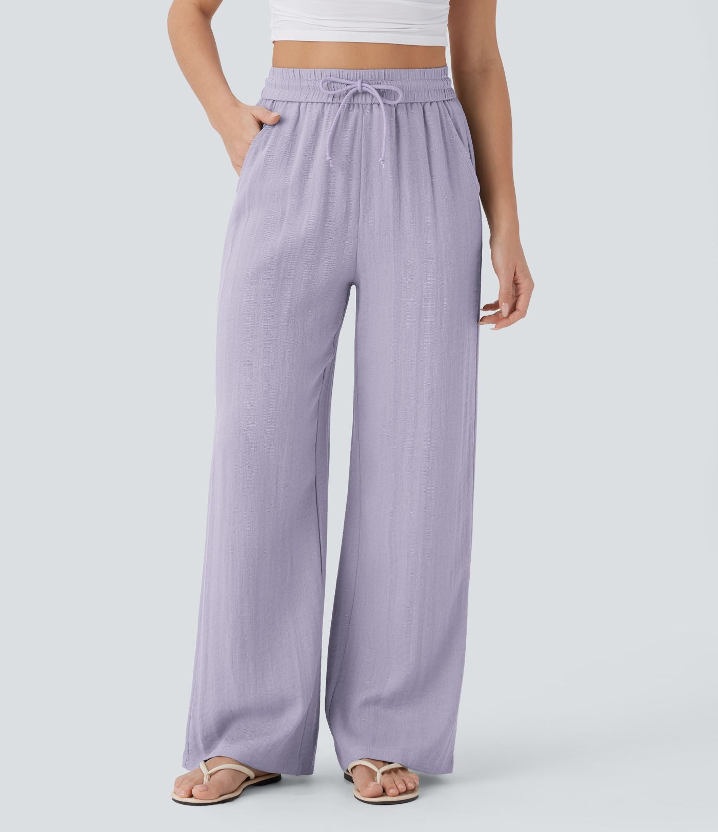 Pantalon large fluide taille haute avec cordon de serrage, poches latérales et aspect lin