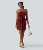 Robe resort mini dos nu à col licou avec lien noué dans le dos et poches