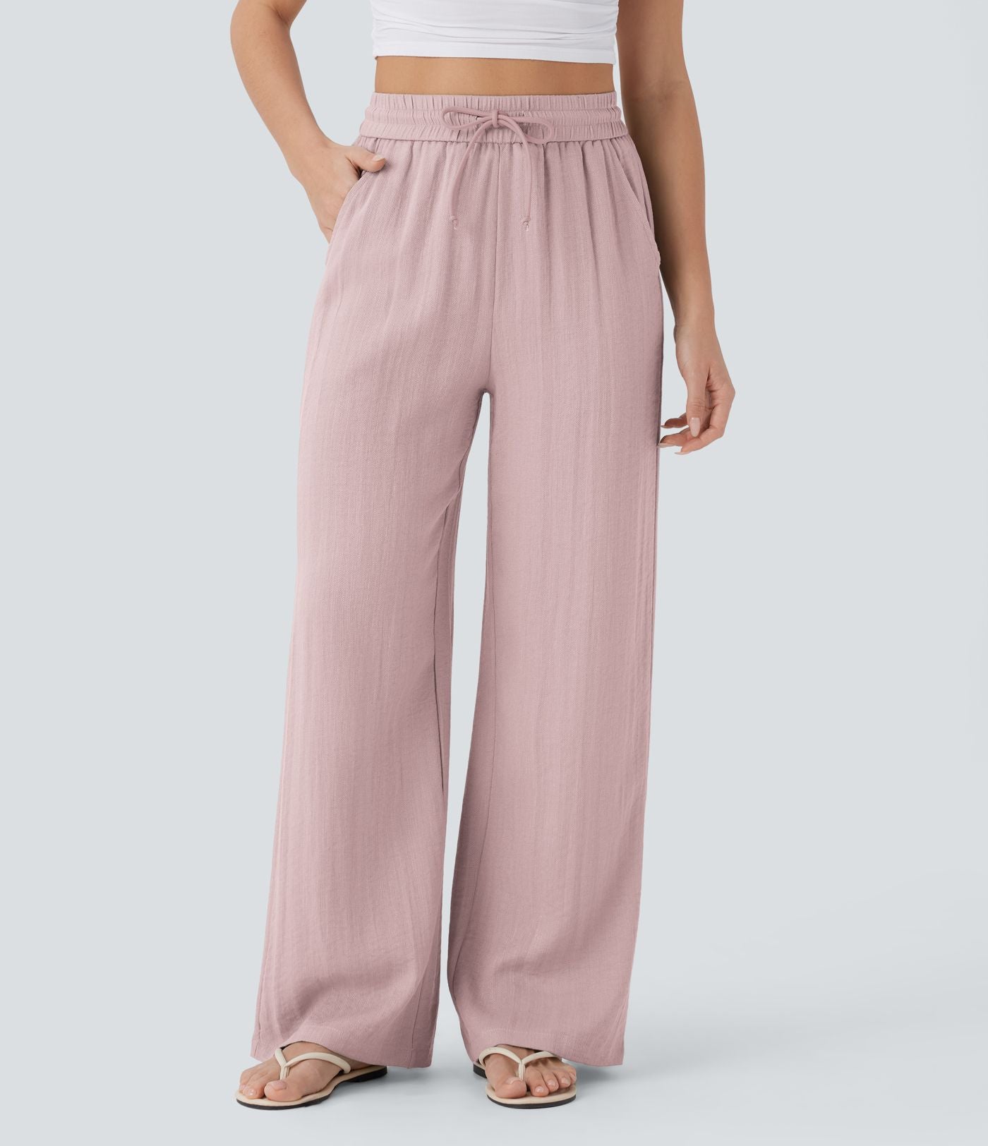 Pantalon large fluide taille haute avec cordon de serrage, poches latérales et aspect lin