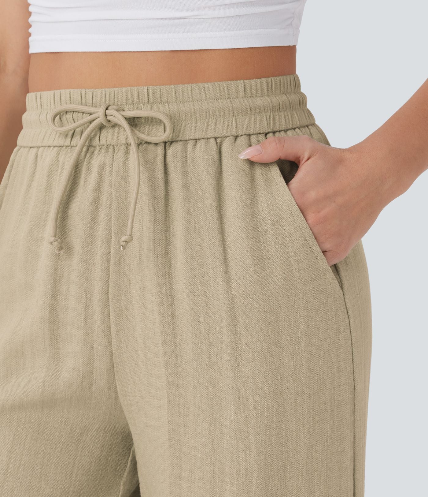 Pantalon large fluide taille haute avec cordon de serrage, poches latérales et aspect lin