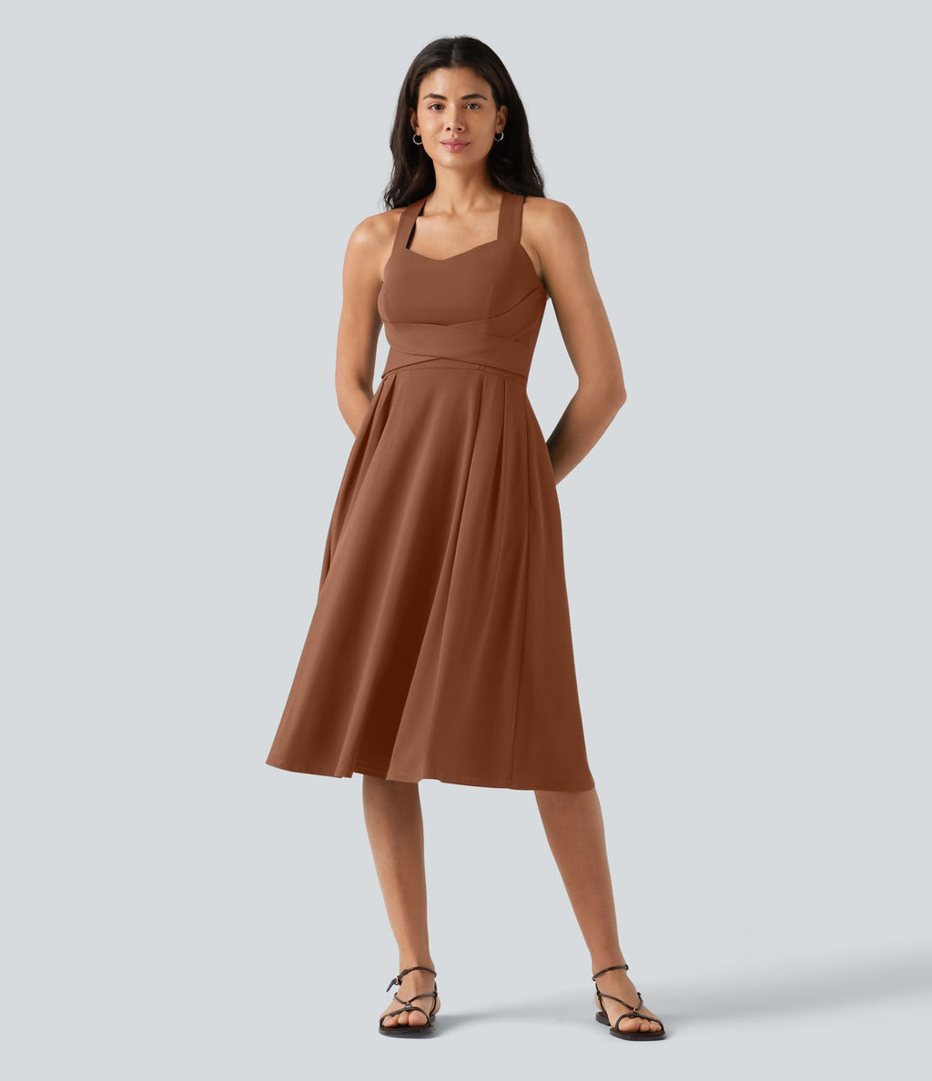 Robe midi fluide sans manches décolleté cœur avec bretelles croisées, nœud dans le dos et poches