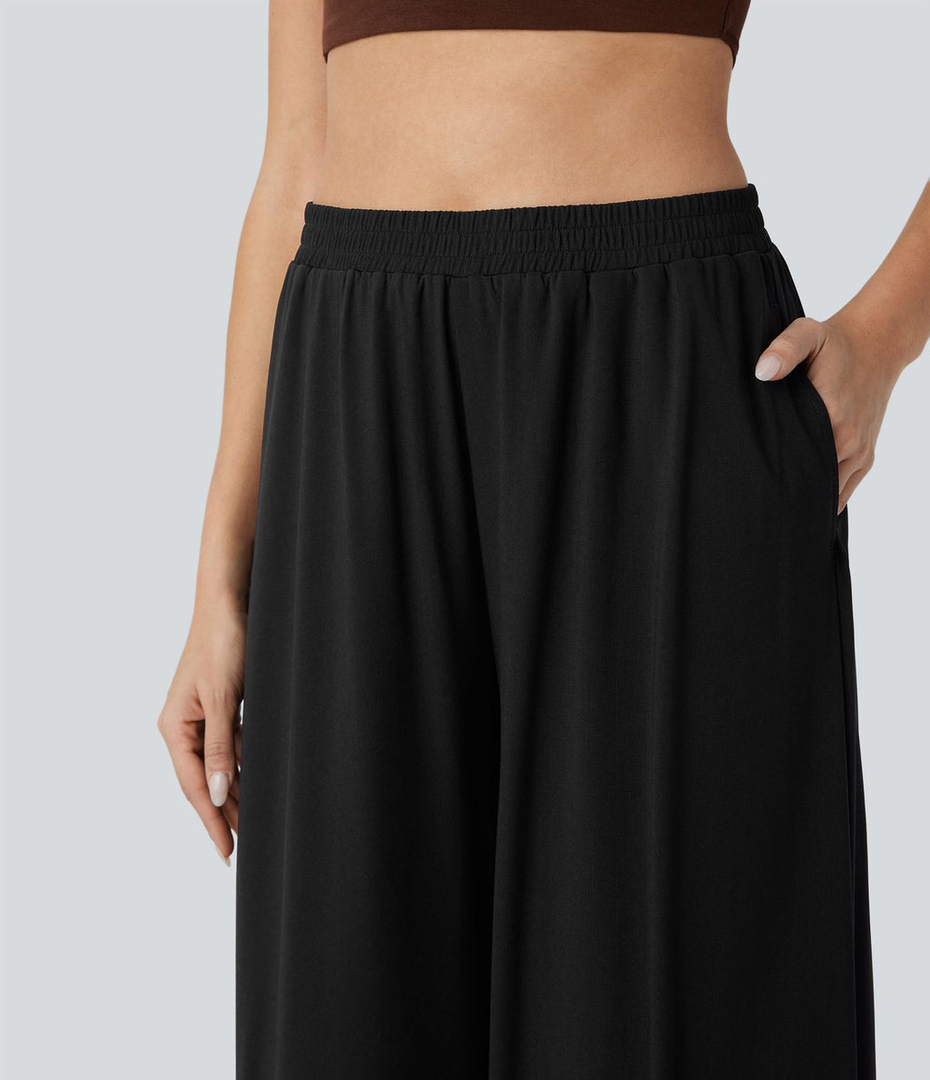 Pantalon fluide et ample avec superposition en mesh, poches latérales et taille haute