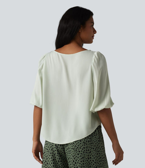 Blouse décontractée à manches bouffantes et ourlet arrondi texturé