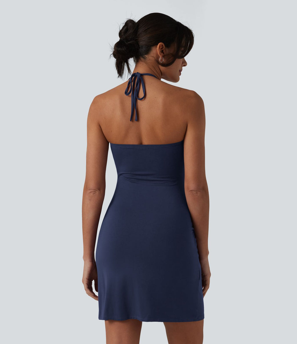Robe resort mini dos nu à col licou avec lien noué dans le dos et poches